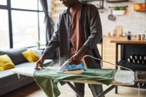 man ironing clothes 300x200